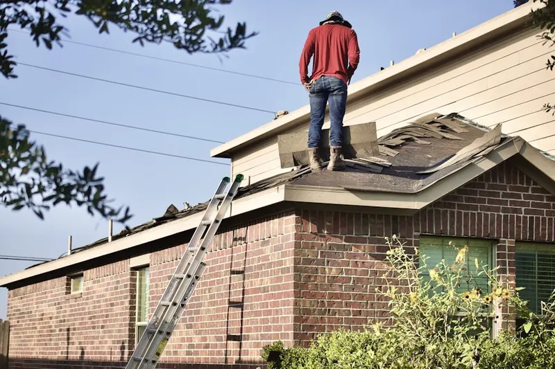 Professional roofer working on a residential roof in West Chester Woods